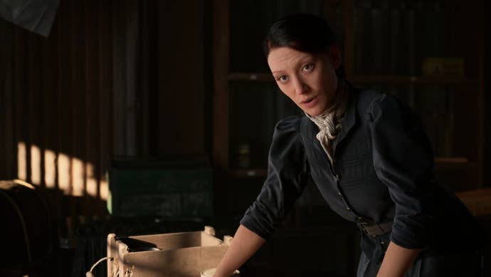 A friend of Hanna's argues with her while writing something at a desk.