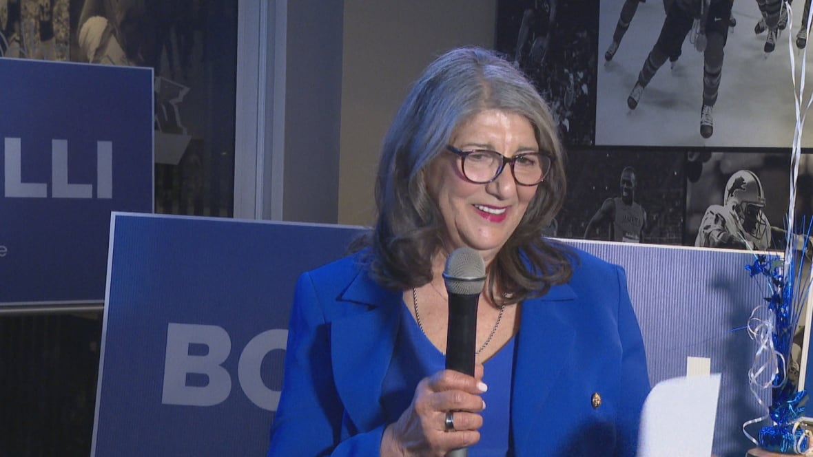 A woman speaks into a microphone