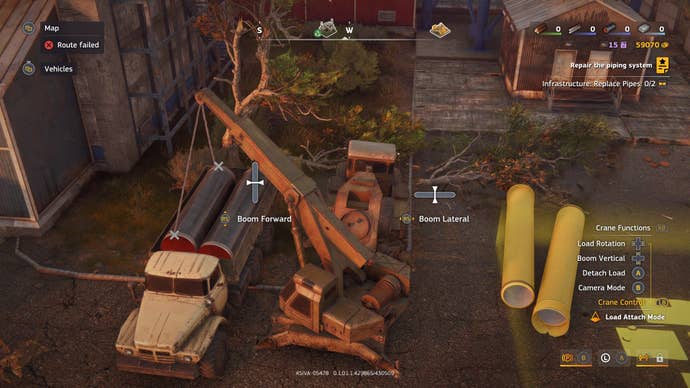 A crane hauls pipes into a cargo truck.