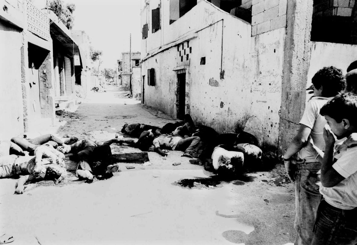 Bodies lie at Sabra and Shatila Palestinian refugee camp in Beirut in this 1982 file photo. Israel hailed a Belgian court decision on Wednesday to throw out a war crimes lawsuit against Israeli Prime Minister Ariel Sharon, but Palestinians said it gave the Israeli Prime Minister the green light for his current military policies.