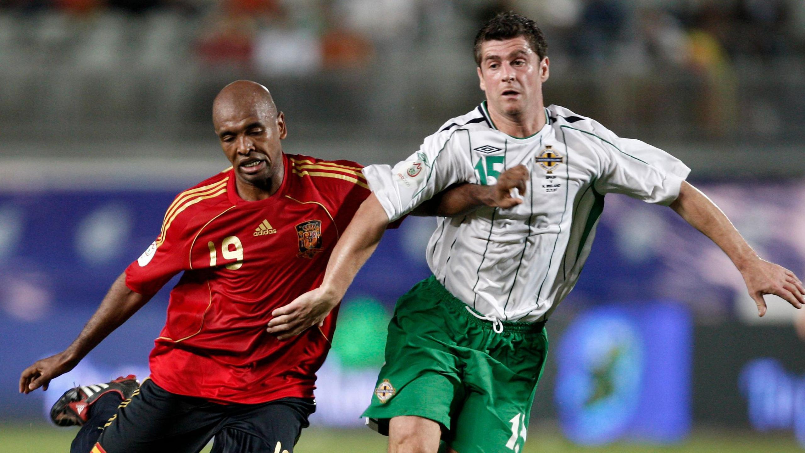 Marcos Senna (L) of Spain duels for the ball with Stephen Robinson of Northern Ireland during the Euro 2008 Group F qualifying match between Spain and Northern Ireland