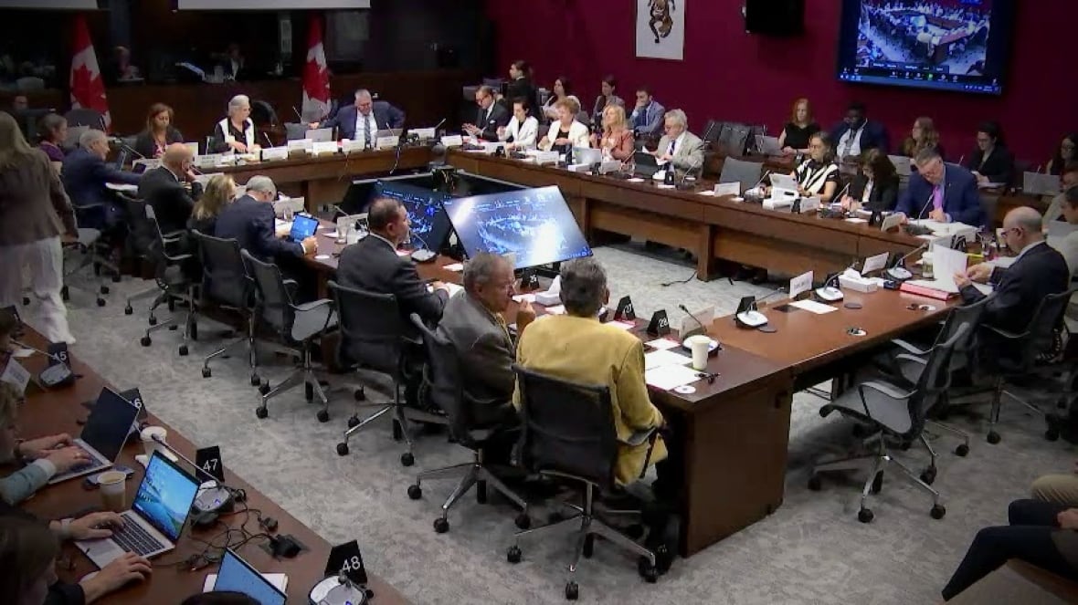 A group of people sitting around a meeting table.