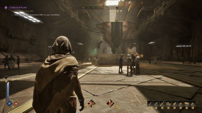 The player stands still while looking down a corridor in a populated settlement.