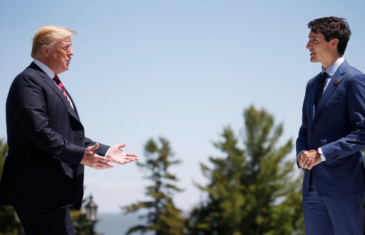 U.S. President Donald Trump approaches Canada's Prime Minister Justin Trudeau as he arrives at the G7 Summit in Charlevoix, Quebec in June 2018.