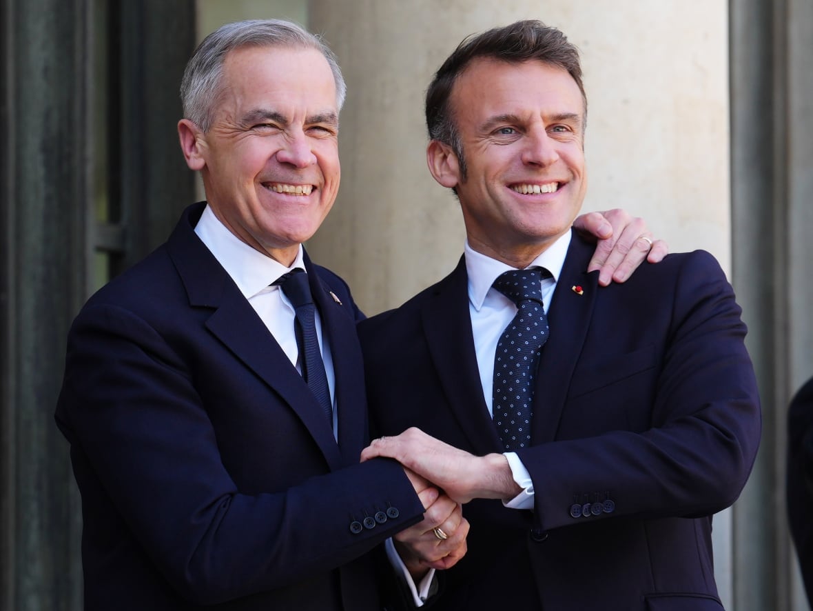 Prime Minister Mark Carney, left, is greeted by President of France Emmanuel Macron as he arrives at the Palais de l'Elysee in Paris, France on Monday, March 17, 2025.