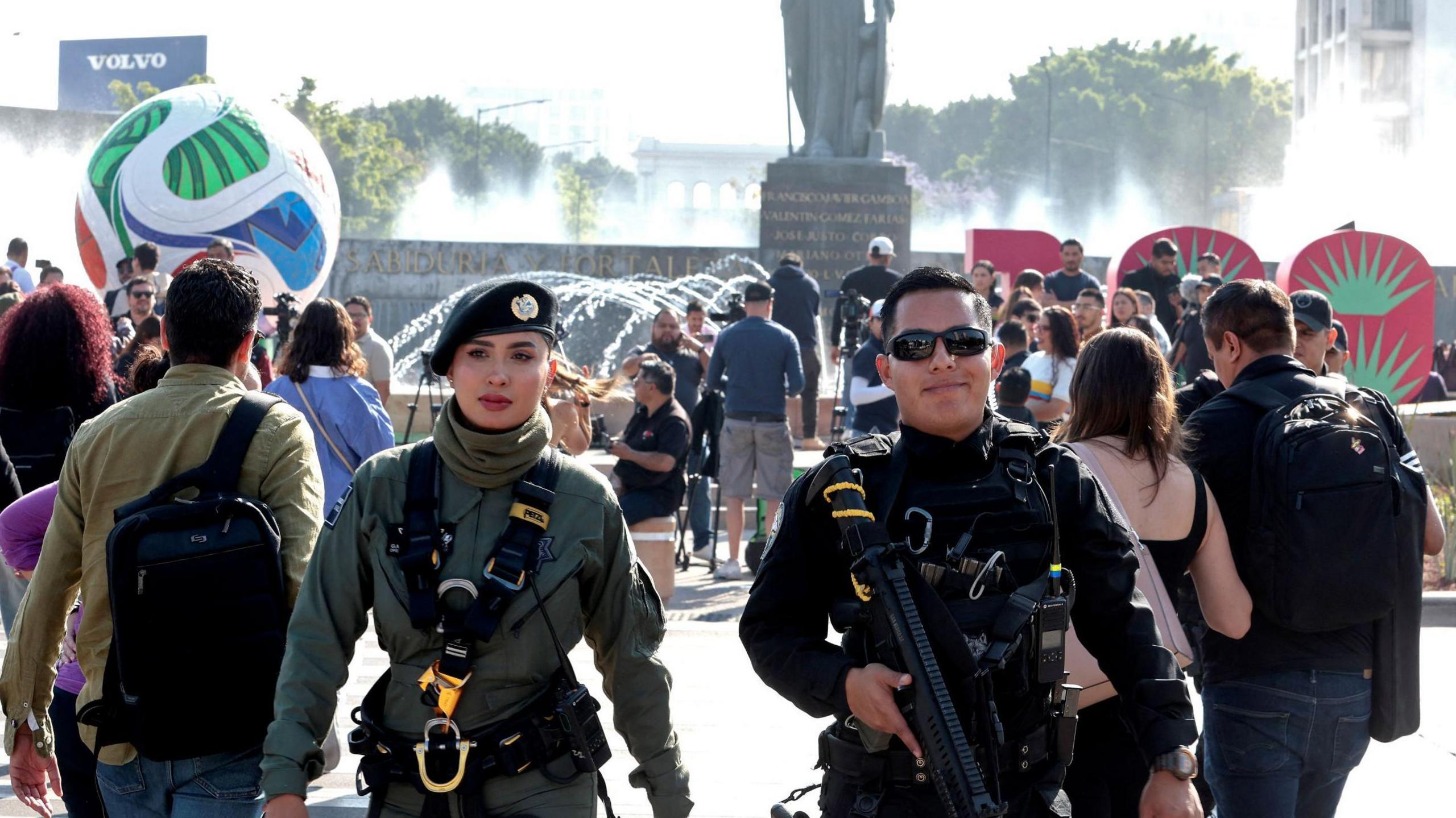 Two police officers guard the area after in front of a giant football installed as part of the 100 days leading up to the 2026 Fifa World Cup, in Guadalajara