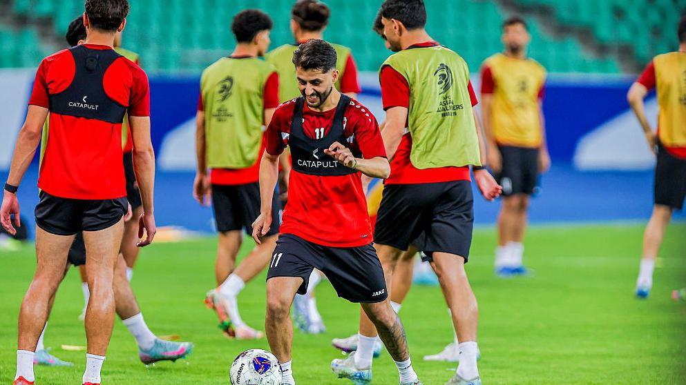 Iraq national team players warm-up on a football pitch