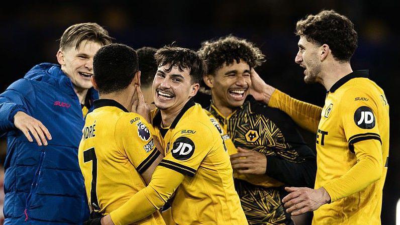 Wolves players celebrate beating Liverpool