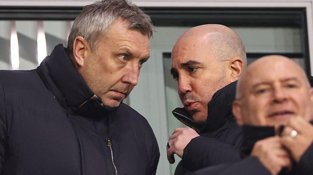 A picture of Jason Wilcox, director of football, and chief executive Omar Berrada chatting in the stands