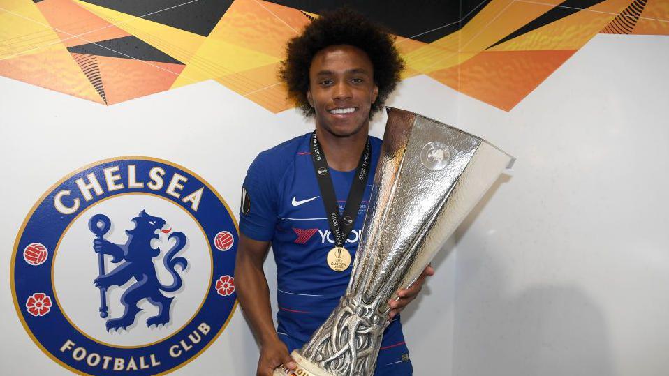 Willian of Chelsea poses for a photo with the UEFA Europa League trophy