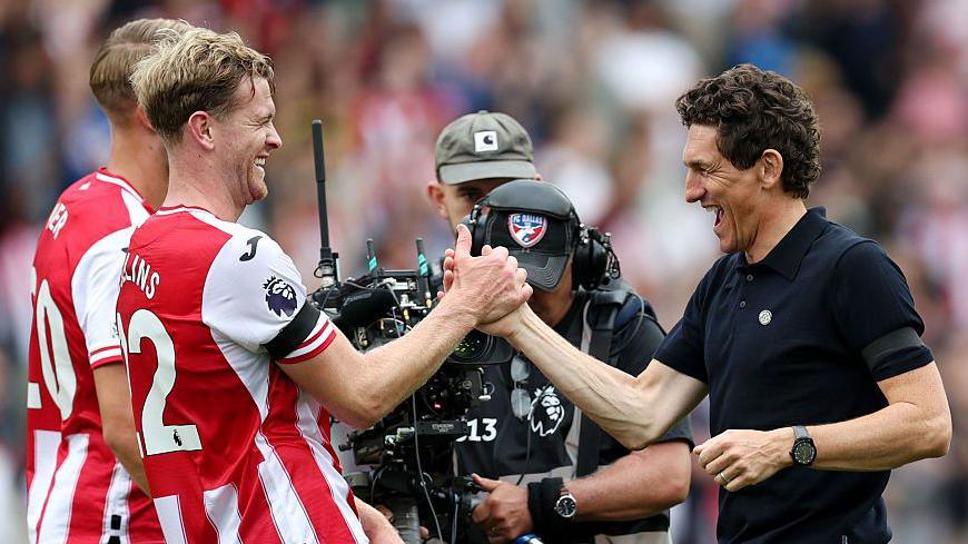 Nathan Collins and Keith Andrews high-five each other