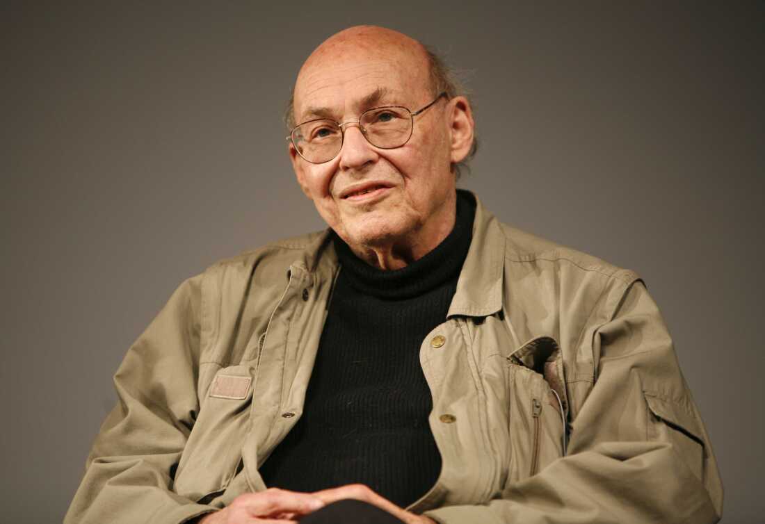 This 2008 photo shows Marvin Minsky photographed from about the waist up. He's wearing a black shirt, a khaki jacket and glasses.
