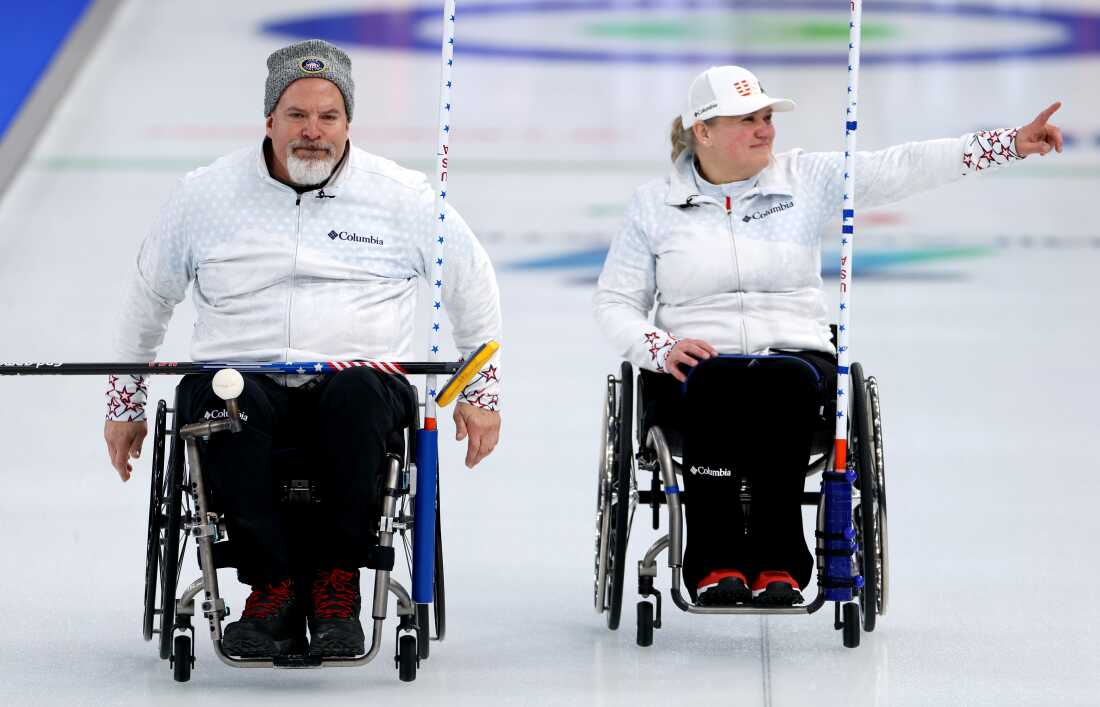 Steve Emt and Laura Dwyer of the U.S. celebrate following their victory in an early wheelchair curling mixed doubles Round Robin match on Wednesday.