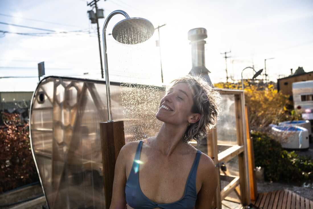 Sophia O&rsquo;Connor, of Bellingham, Wash., rinses off after a sauna session, while participating in the Seattle Sauna Festival.