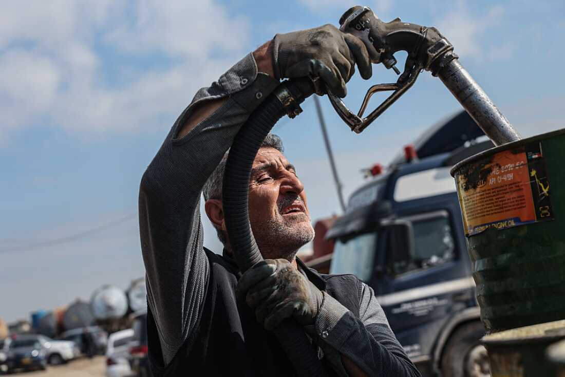 A worker at a market for fuel oil and automotive fuel on March 17, 2026 in Erbil, Iraq. Recent drone attacks in the region have forced some oil refineries here to cease operation, while others continue.