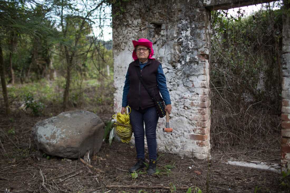 Hilaria Arzaba Medran, 57, poses for a photo with tools as she searches for her disappeared son and other victims in a location known to have been a clandestine grave. Ilaria's son Oscar Contreras Arzaba disappeared on May 22, 2011, at the age of 19. Ilaria is a member of Solecito, an organization of more than 250 family members with numerous chapters throughout the State of Veracruz, who go out and search for their missing relatives nearly on a daily basis. Cordoba, Veracruz, Mexico. February 20, 2018. James Rodr&iacute;guez / Everyday Latin America Reason for selection: &ldquo;Women risking their lives in search of their loved ones is a common theme in the work I do. Yet it never ceases to amaze me.&rdquo; Published in Le Monde: https://www.lemonde.fr/international/portfolio/2018/06/22/tous-les-maux-du-mexique-reunis-au-veracruz_5319874_3210.html