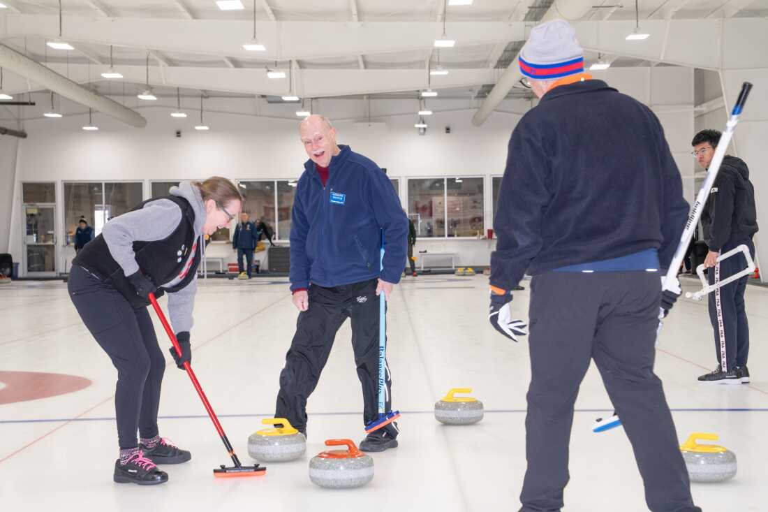 Howard Griffin laughs while playing with other members of the Potomac Curling Club. He has been curling for over 20 years.